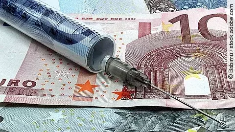 Finanzspritze Spritze liegt auf Geldscheinen