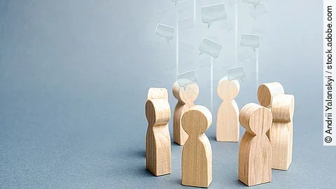 Gespräch Kleine Holzfiguren sind in einem Kreis angeordnet
