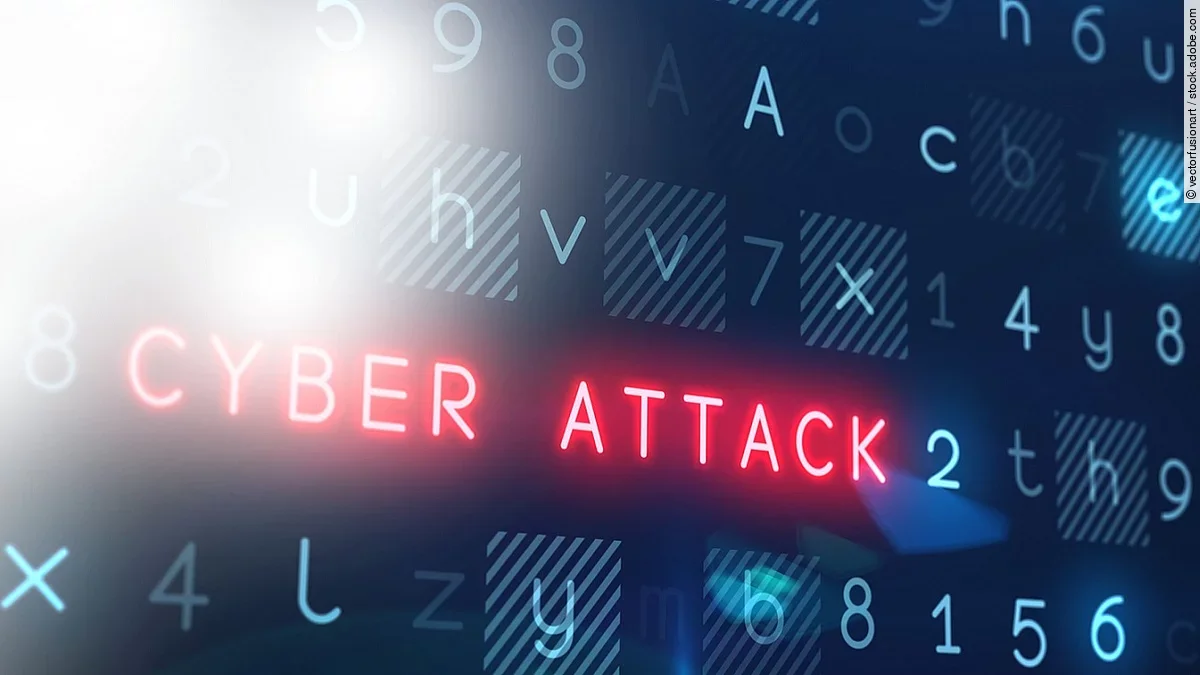 Cyberattacke In einem Raster aus blauen Ziffern und Buchstaben leuchtet der Begriff "Cyber Attack" rot auf.