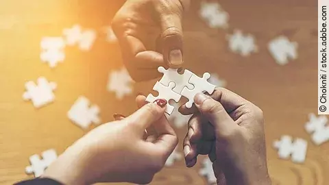 Zusammenschluss Drei Hände setzen drei Puzzlestücke zusammen