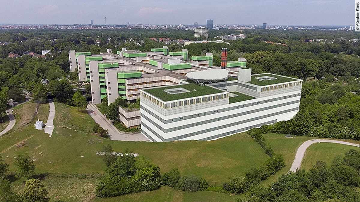 Ein Gebäude, von oben, umgeben von einer Wiese.