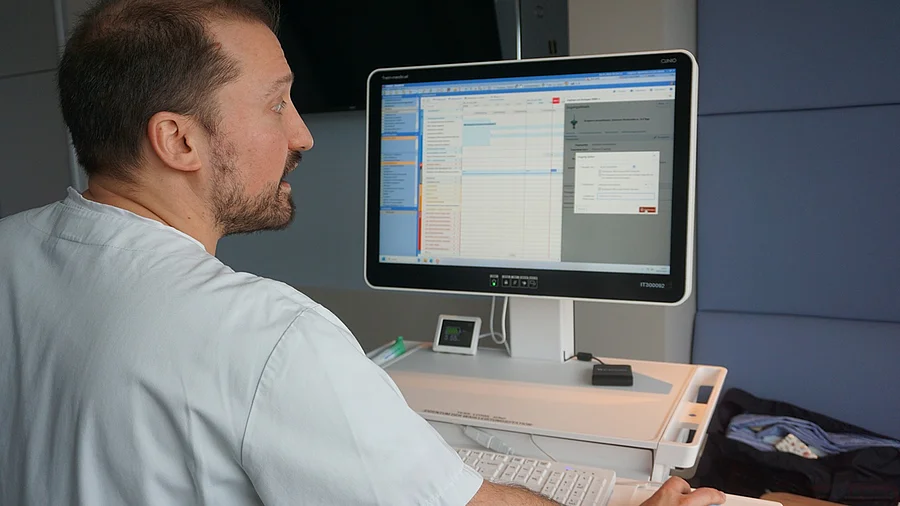 Stationsleiter Hirschmann am Monitor. Stationsleiter Hirschmann blickt auf den Monitor.