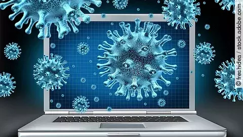 Ein aufgeklappter Laptop umgeben von schwebenden Viren (kugelförmige Objekte mit Noppen).