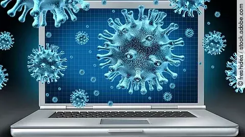 Ein aufgeklappter Laptop umgeben von schwebenden Viren (kugelförmige Objekte mit Noppen).