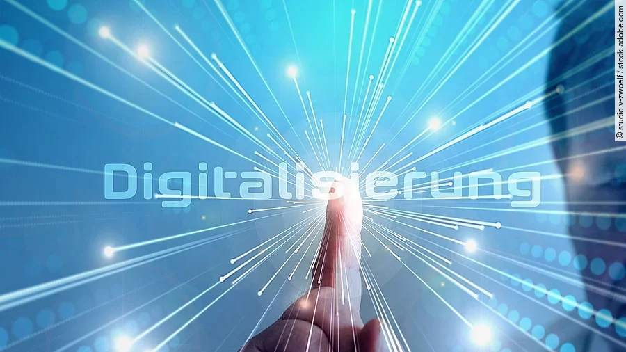 Grafik mit dem Wort "Digitalisierung" im Mittelpunkt. Lichtstrahlen gehen vom Mittelpunkt aus.