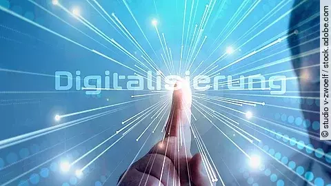 Grafik mit dem Wort "Digitalisierung" im Mittelpunkt. Lichtstrahlen gehen vom Mittelpunkt aus.