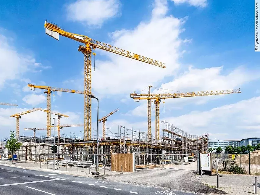 Großbaustelle an einer Straße mit mehreren Kränen.